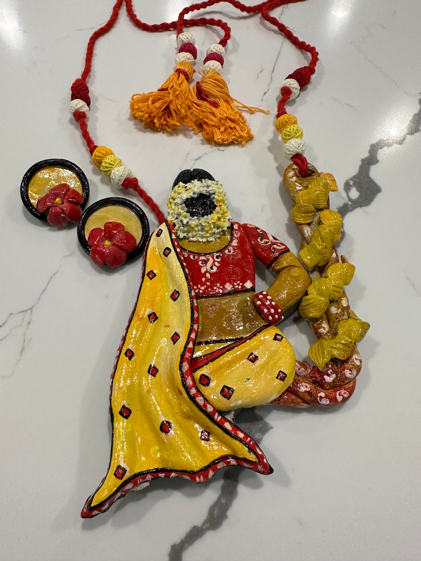 Artificial Clay Jewelry - Lady draped in a saree sitting on a flower swing (Yellow)